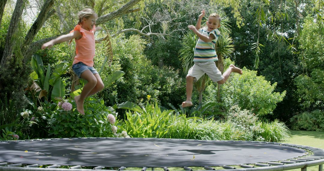 Happy Children Jumping on Trampoline in Garden - Free Images, Stock Photos and Pictures on Pikwizard.com