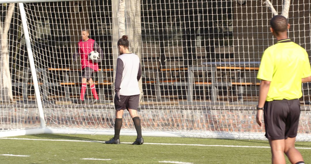 Young Soccer Player Behind Goal Net During Game