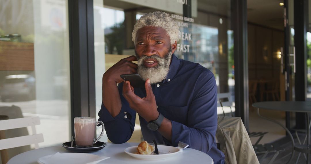 Middle-Aged Man Talking on Phone While Having Breakfast at Outdoor Cafe - Free Images, Stock Photos and Pictures on Pikwizard.com