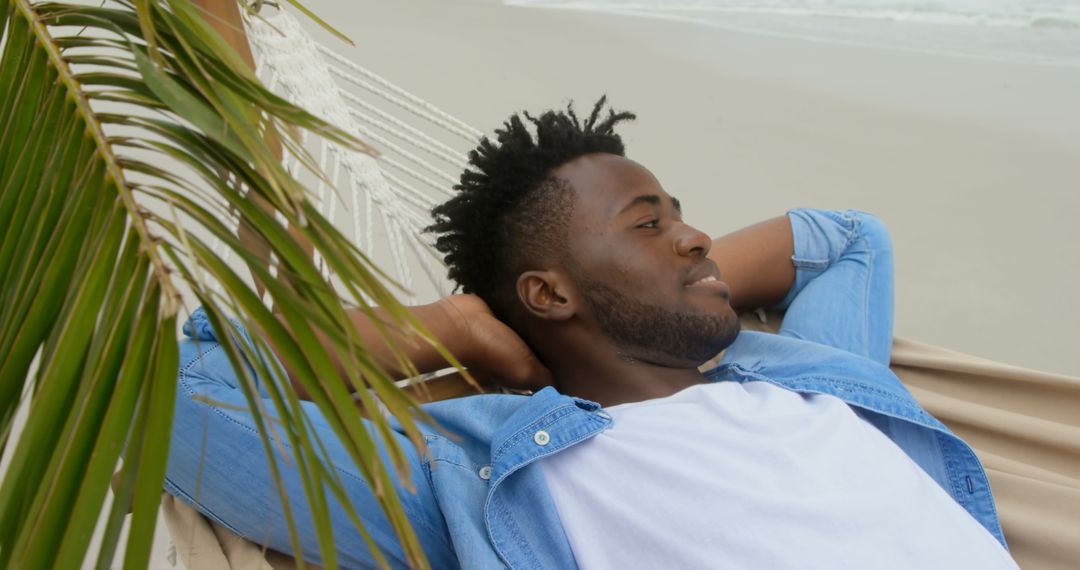 Relaxing Escape: Man Enjoying Hammock on Serene Beach
