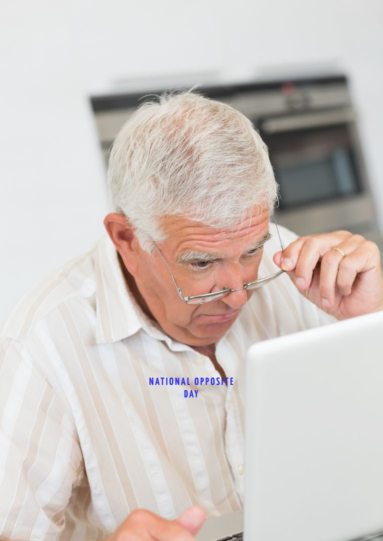 Curious Elderly Man Using Laptop Celebrating National Opposite Day - Free Images, Stock Photos and Pictures on Pikwizard.com