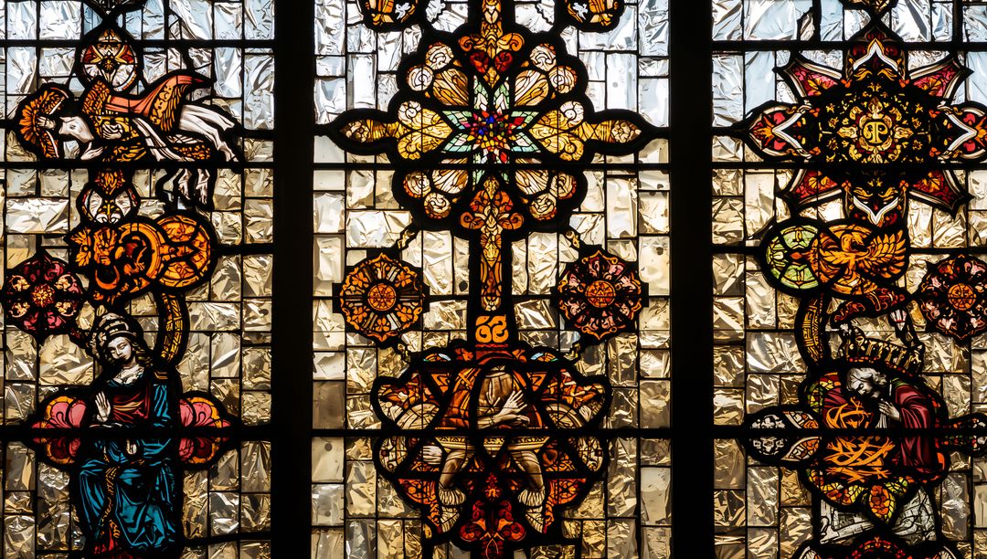 Ornate Stained Glass Window with Cross Motif and Sunlit Illumination