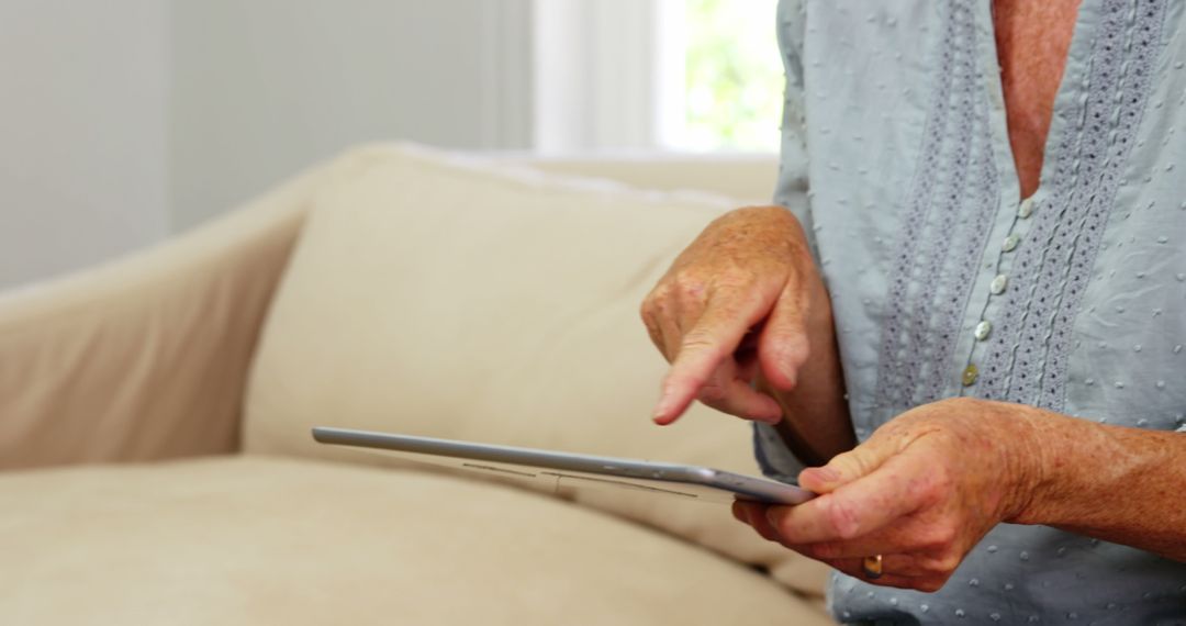 Senior Woman Using Digital Tablet on Couch - Free Images, Stock Photos and Pictures on Pikwizard.com