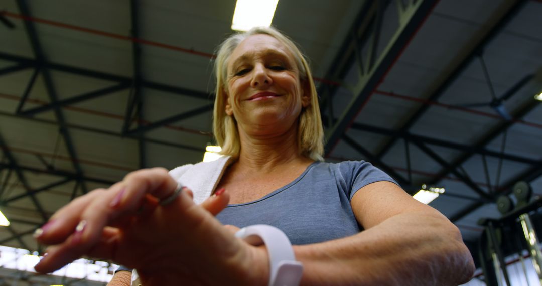 Older woman using smartwatch during workout in gym - Free Images, Stock Photos and Pictures on Pikwizard.com