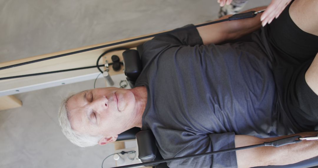 Senior Man Exercising Using Pilates Reformer Machine - Free Images, Stock Photos and Pictures on Pikwizard.com