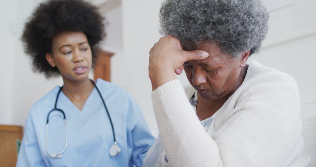 Caring african american female doctor and sad senior female talking - Free Images, Stock Photos and Pictures on Pikwizard.com