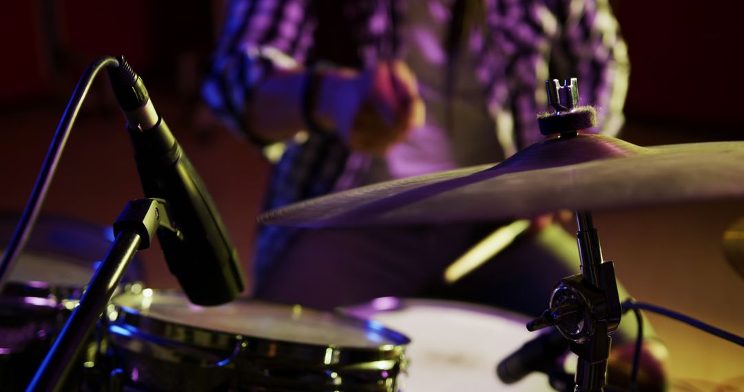 A biracial man with dreadlocks plays drums in a studio recording session. - Free Images, Stock Photos and Pictures on Pikwizard.com