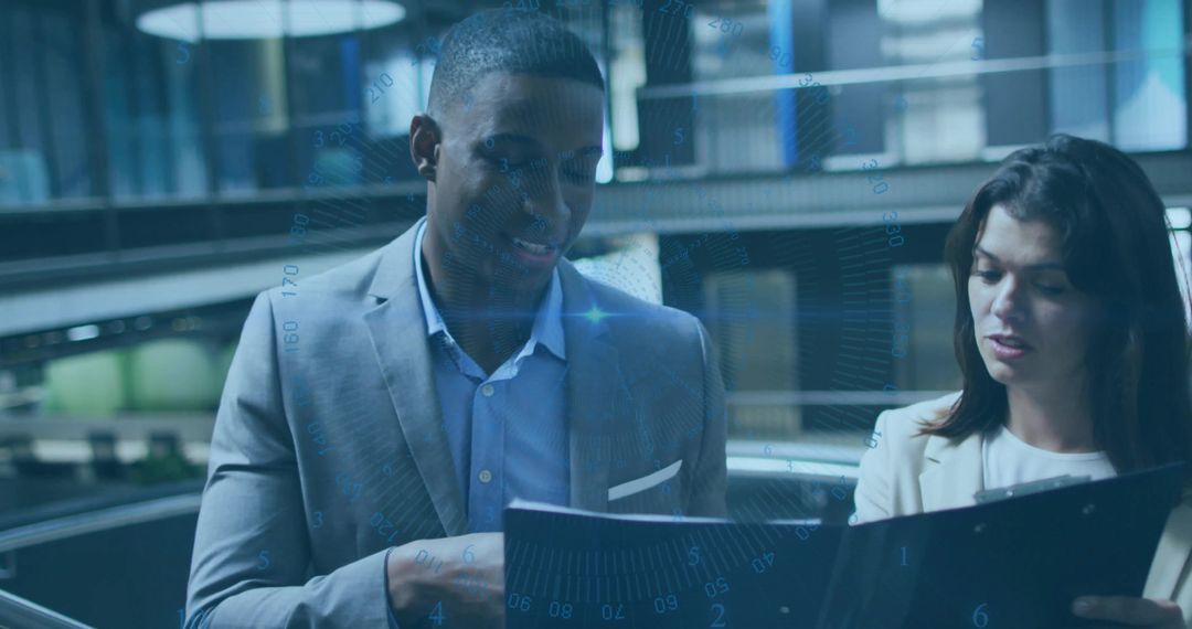 Colleagues Collaborating on Documents Amidst Digital Interface