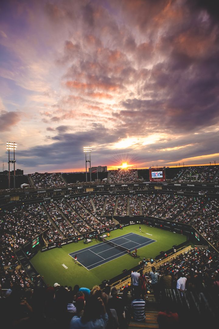 Aerial View of Tennis Stadium at Sunset with Crowd Watching Live Match - Free Images, Stock Photos and Pictures on Pikwizard.com