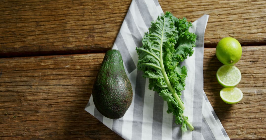 Fresh Avocado, Kale, and Lime on Rustic Wooden Surface - Free Images, Stock Photos and Pictures on Pikwizard.com