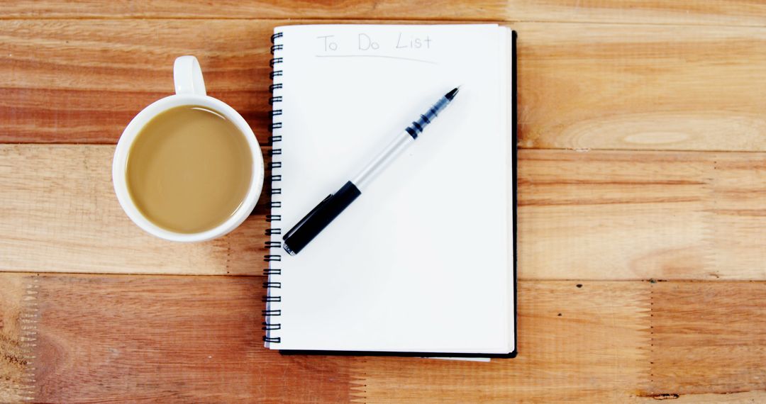 A cup of coffee sits next to a 'To Do List' notepad and a pen on a wooden surface, with copy space - Free Images, Stock Photos and Pictures on Pikwizard.com
