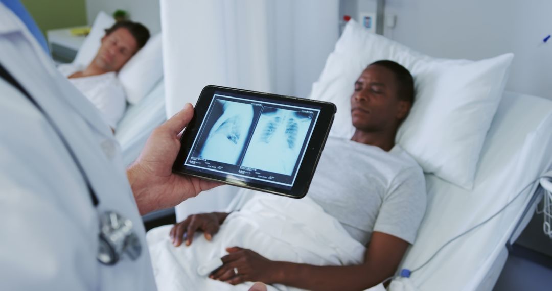 Doctor showing patient chest X-rays on digital tablet in hospital ward - Free Images, Stock Photos and Pictures on Pikwizard.com