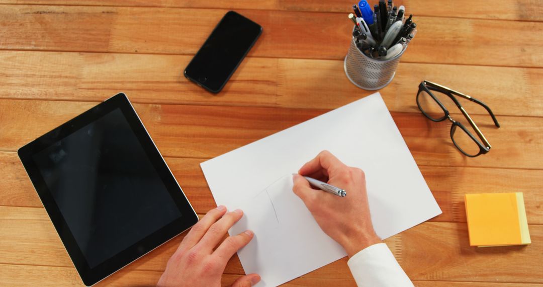 Person Drawing on White Paper at Office Desk with Tablet and Stationery - Free Images, Stock Photos and Pictures on Pikwizard.com