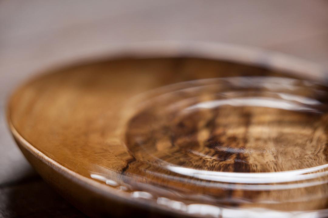 Water Ripples in Wooden Bowl on Wooden Table - Free Images, Stock Photos and Pictures on Pikwizard.com