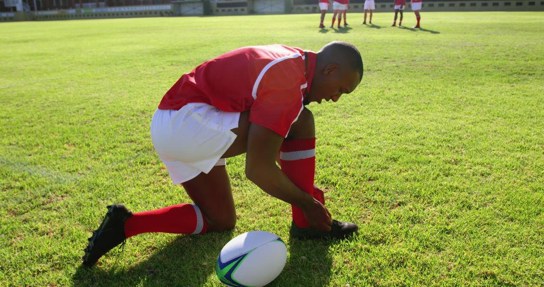 Rugby Player Tying Shoe On Field Before Game - Free Images, Stock Photos and Pictures on Pikwizard.com