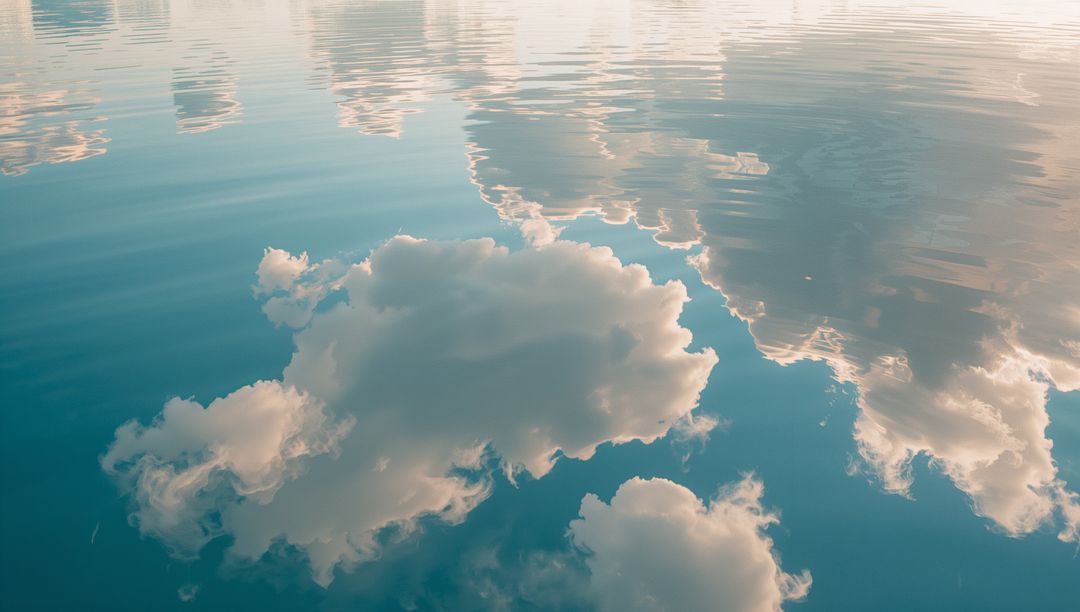 Serene Cloud Reflections on Tranquil Water Surface