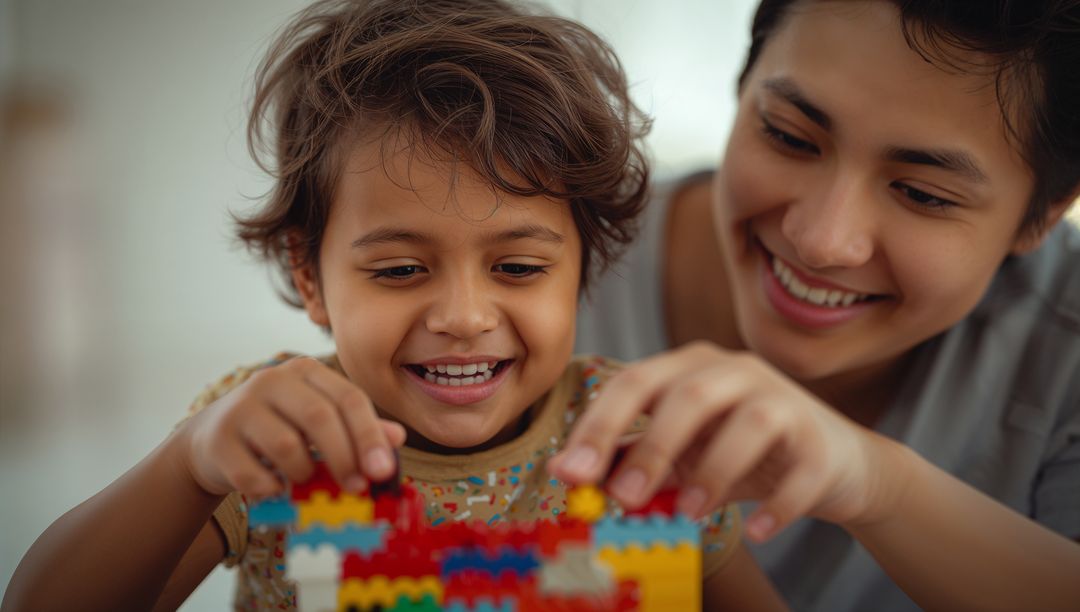 Mother and Child Building with Blocks in Playroom