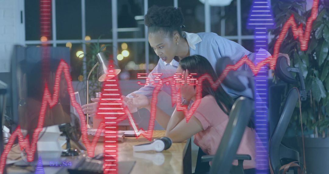 Businesswomen Analyzing Finance Data in Modern Office Setting