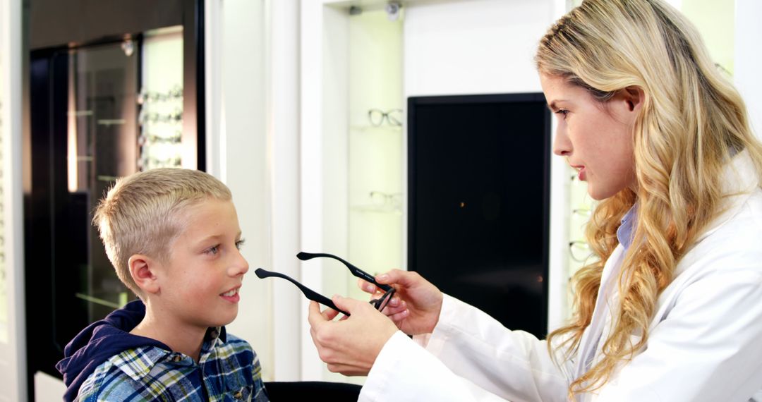 Optometrist Helping Boy Choose Eyeglasses - Free Images, Stock Photos and Pictures on Pikwizard.com