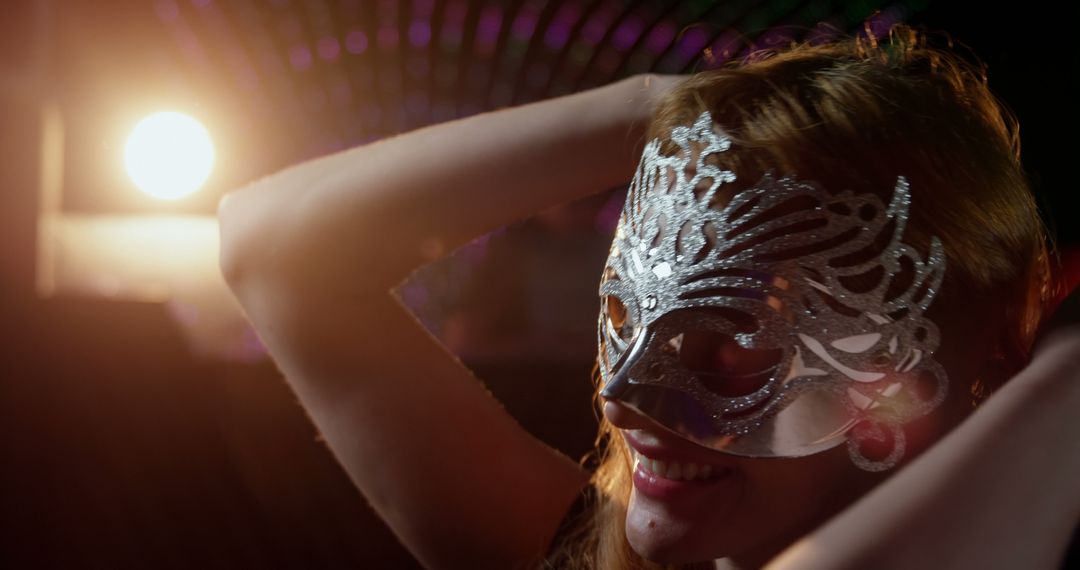 Woman Smiling Wearing Silver Masquerade Mask at Nightclub - Free Images, Stock Photos and Pictures on Pikwizard.com