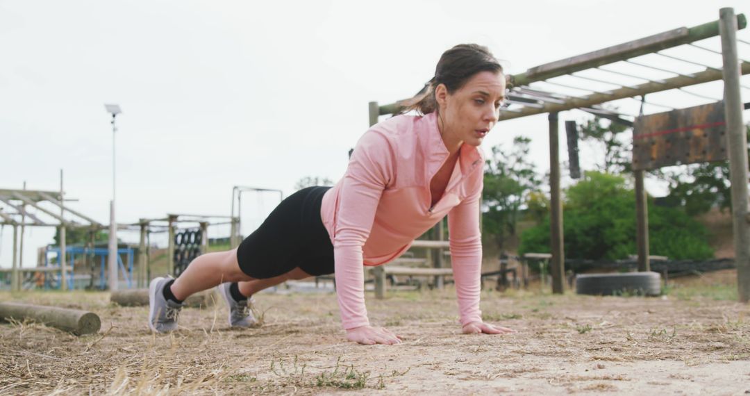 Woman Doing Push-Ups in Outdoor Fitness Area - Free Images, Stock Photos and Pictures on Pikwizard.com