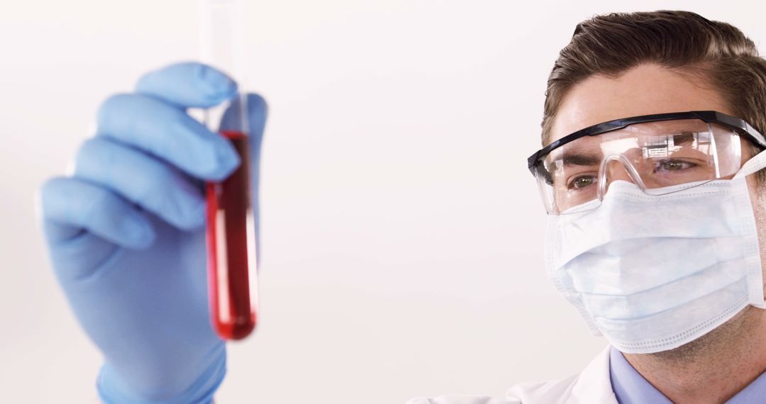 Lab Technician Examining Blood Sample with Protective Gear
