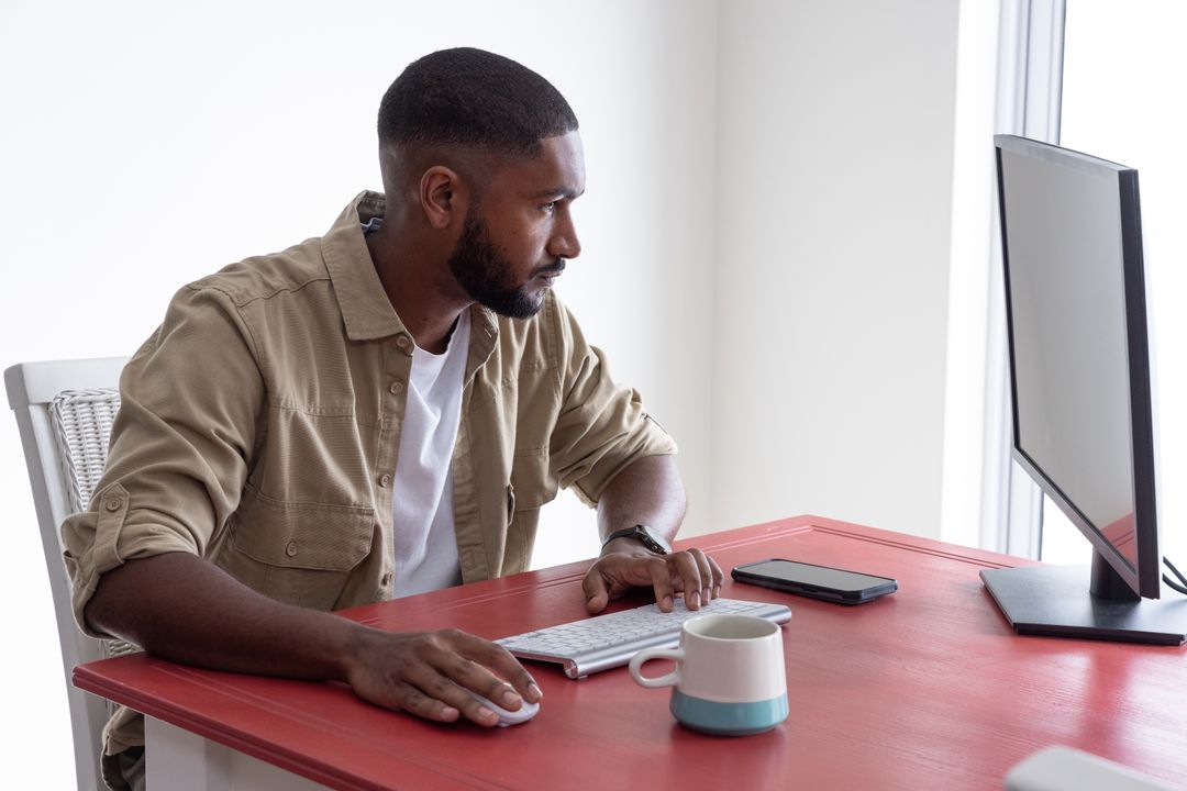 Focused Professional Using Monitor in Home Office Minimalist Design