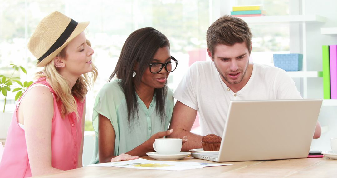 Young Professionals Collaborating on Project with Laptop