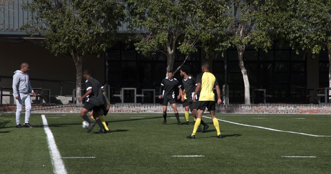Soccer Players Deep in Strategic Team Practice on Sunny Field