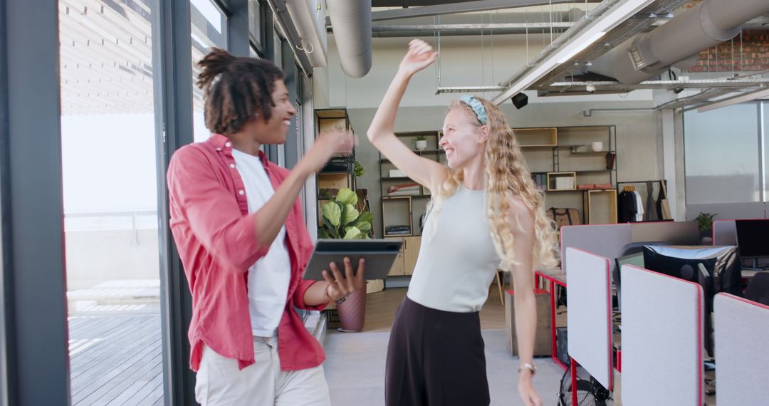 Colleagues Rejoicing Over Successful Project in Modern Office Environment