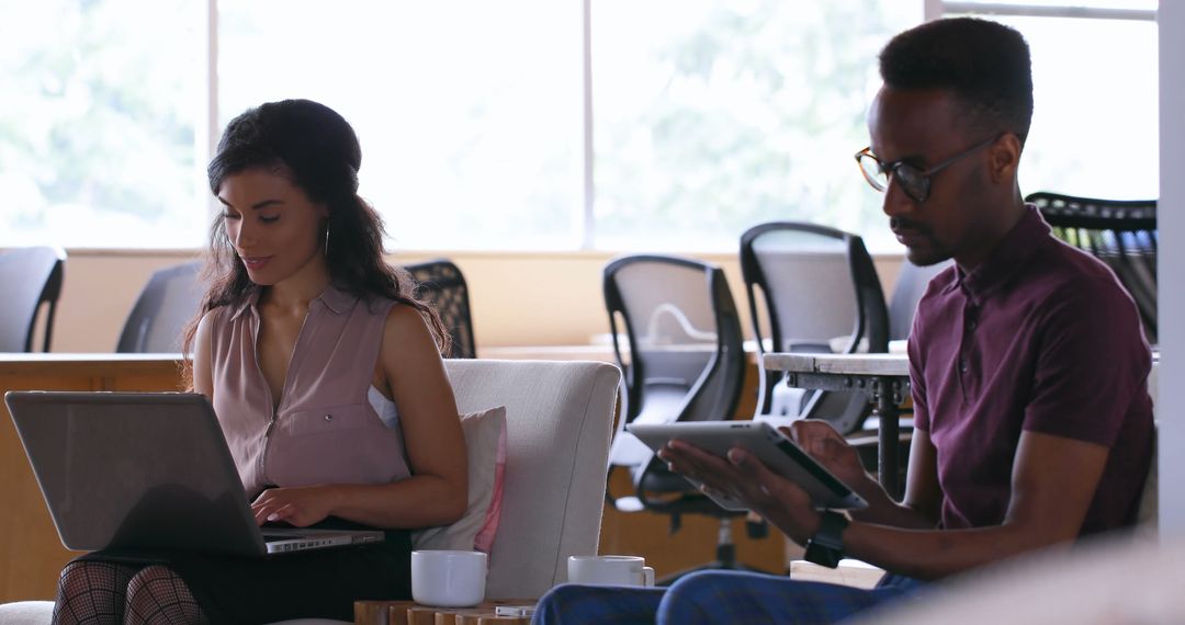 Focused Young Professionals Collaborating in Modern Office Setting