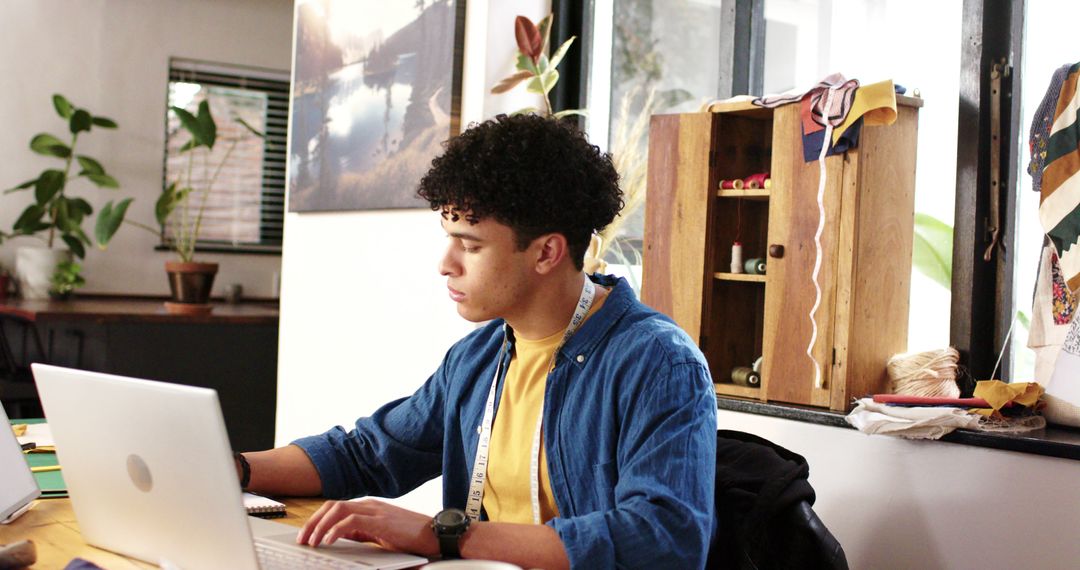 Young Man Focused on Laptop in Home Office - Free Images, Stock Photos and Pictures on Pikwizard.com