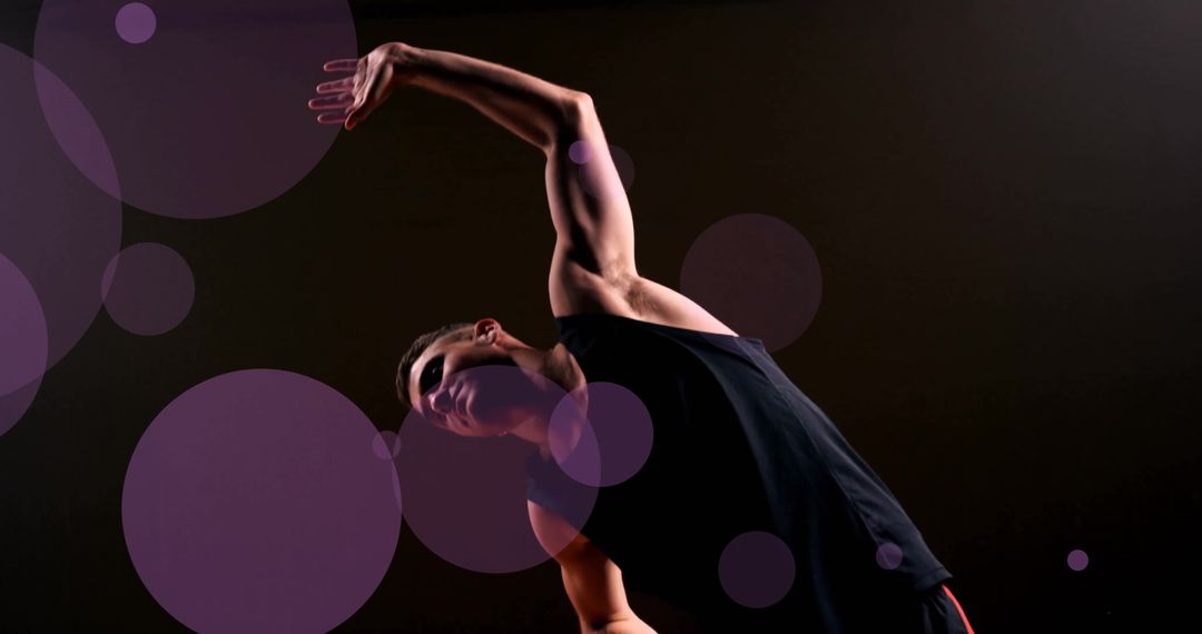 Fit Caucasian Male Stretching in Dark Gym Setting
