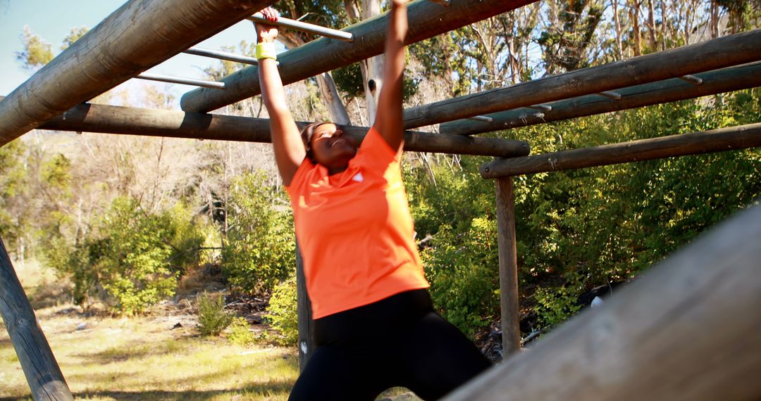 Determined Woman Practices Fitness on Outdoor Monkey Bars - Free Images, Stock Photos and Pictures on Pikwizard.com