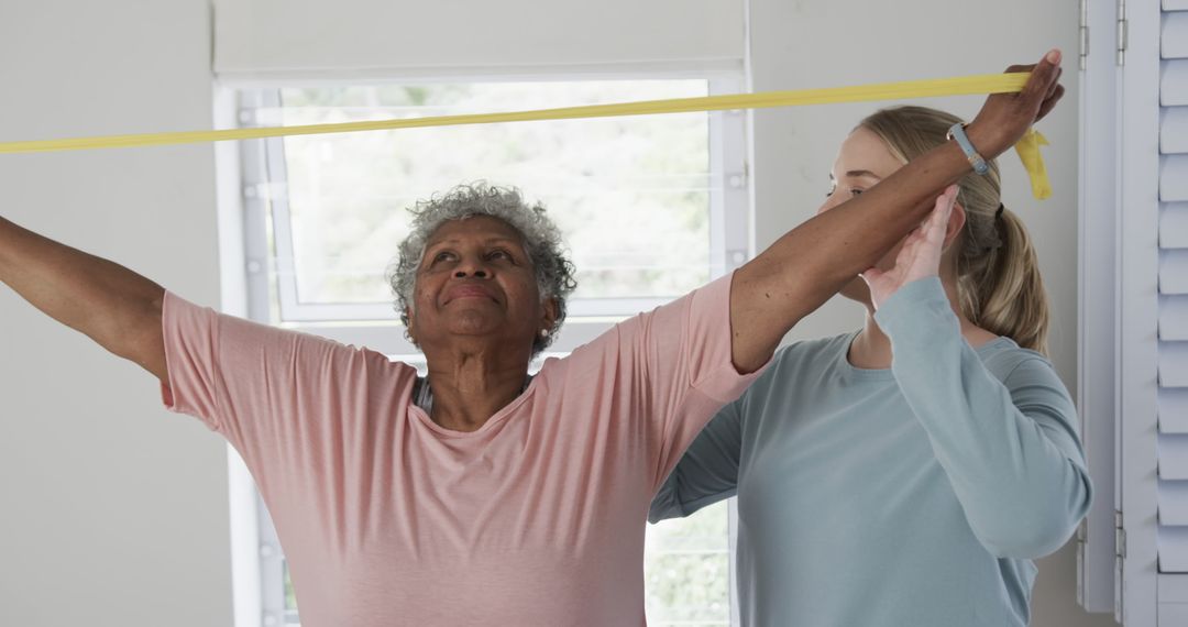 Physical Therapist Assisting Elderly Woman with Resistance Band Exercise - Free Images, Stock Photos and Pictures on Pikwizard.com