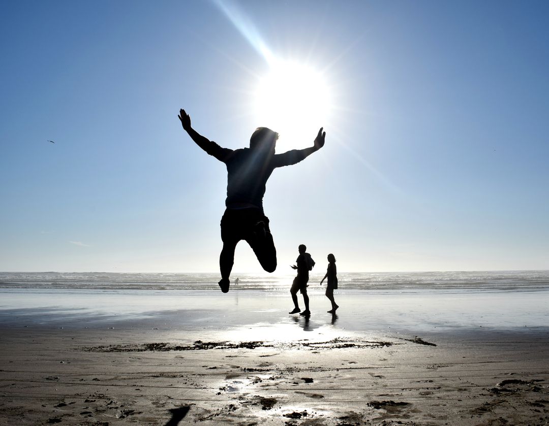 Silhouette of Young Man Jumping on Beach at Sunset - Free Images, Stock Photos and Pictures on Pikwizard.com