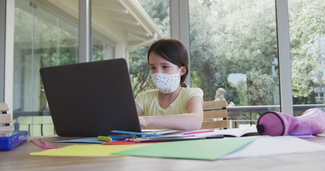 Young Girl Studying Online at Home Wearing Face Mask - Free Images, Stock Photos and Pictures on Pikwizard.com