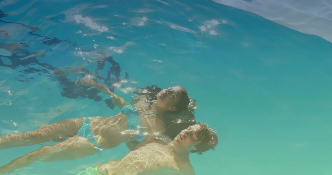 Couple Floating in Clear Turquoise Water Embracing Relaxation