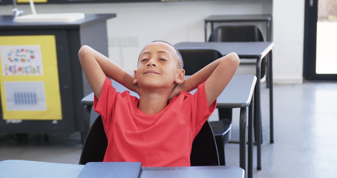 Young Boy Relaxing in Classroom during Study Break Slow Motion