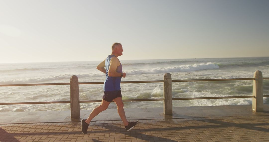 Senior Man Jogging Along Seaside Promenade at Sunrise - Free Images, Stock Photos and Pictures on Pikwizard.com