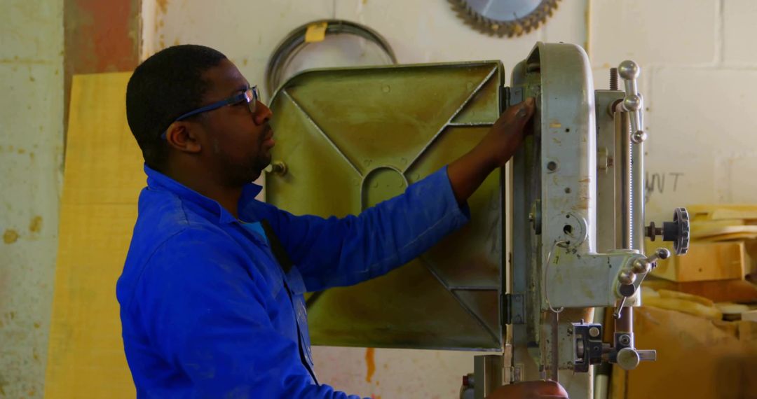Woodworker Operating Band Saw in Carpentry Workshop