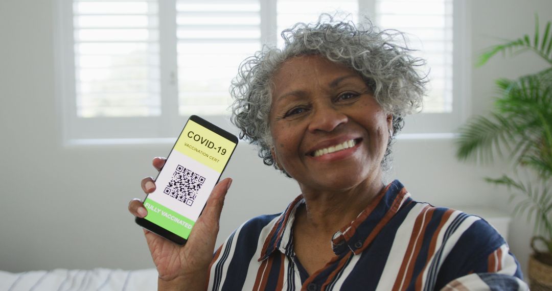 Happy Senior Woman Showing COVID-19 Vaccination QR Code on Smartphone - Free Images, Stock Photos and Pictures on Pikwizard.com