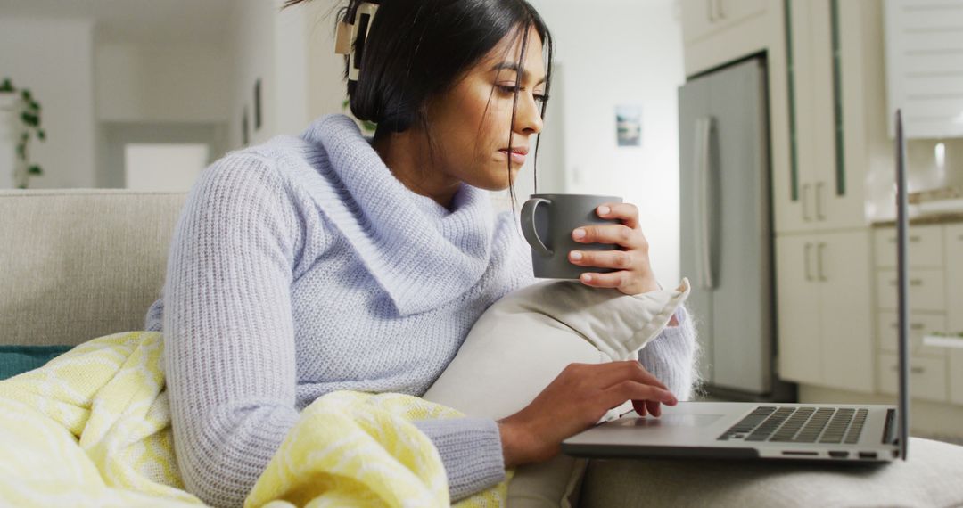 Woman Drinking Coffee while Browsing Laptop at Home - Free Images, Stock Photos and Pictures on Pikwizard.com