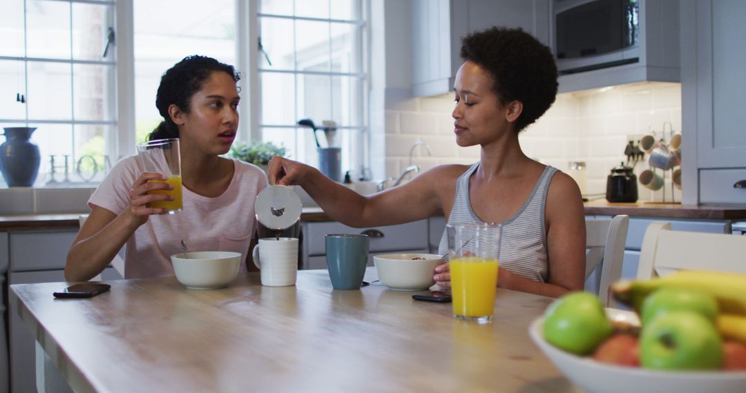 Two Women Having Breakfast in Modern Kitchen - Free Images, Stock Photos and Pictures on Pikwizard.com