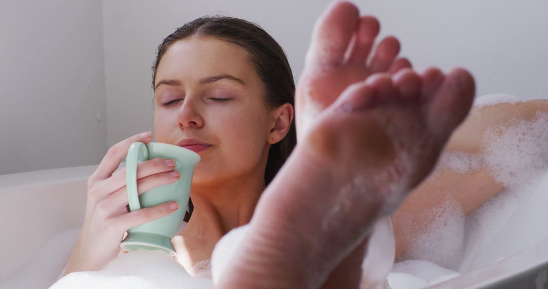 Woman Relaxing in Bubble Bath with Cup of Tea - Free Images, Stock Photos and Pictures on Pikwizard.com