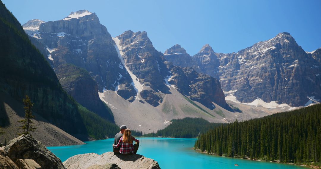 Couple Enjoying Scenic View of Mountain Lake in Summer - Free Images, Stock Photos and Pictures on Pikwizard.com