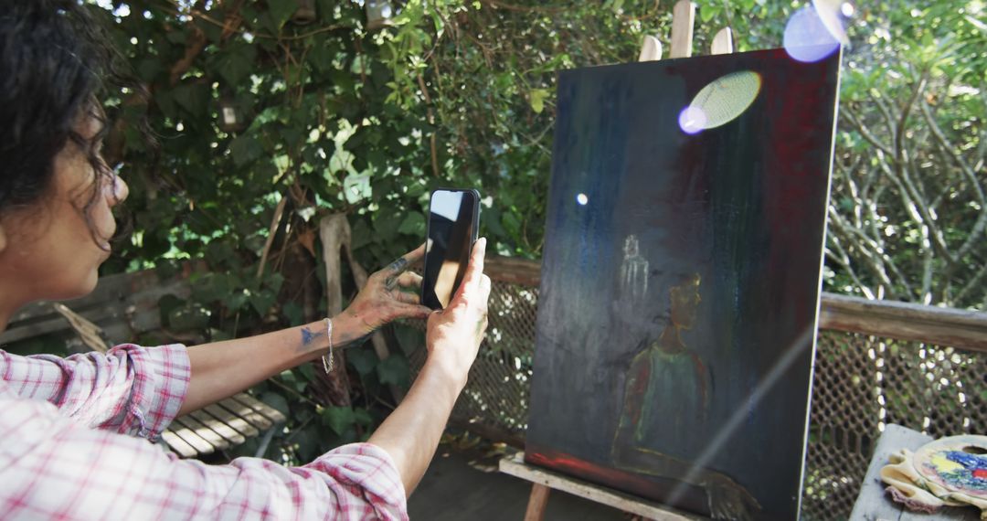 Artist Capturing Their Artwork with Smartphone in Outdoor Studio - Free Images, Stock Photos and Pictures on Pikwizard.com