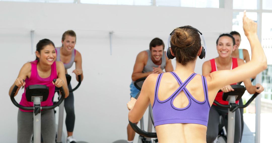 Group Indoor Cycling Class with Enthusiastic Instructor - Free Images, Stock Photos and Pictures on Pikwizard.com