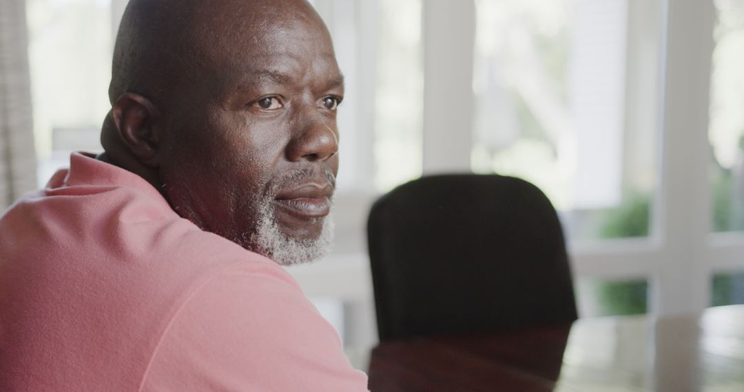 Mature Man in Thoughtful Pose Sitting at Home - Free Images, Stock Photos and Pictures on Pikwizard.com