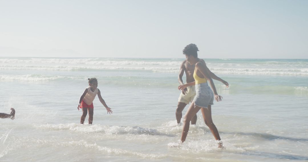 Happy Family Playing at Beach on Sunny Day - Free Images, Stock Photos and Pictures on Pikwizard.com